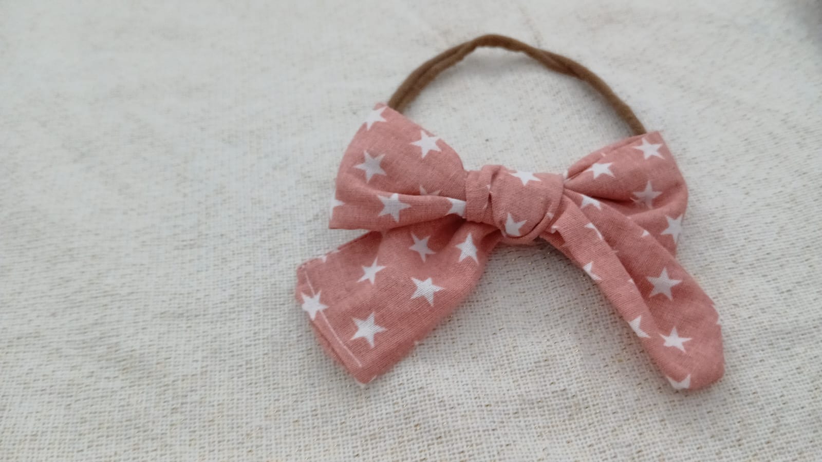Hoofdband met oranje strik en witte sterrenprint